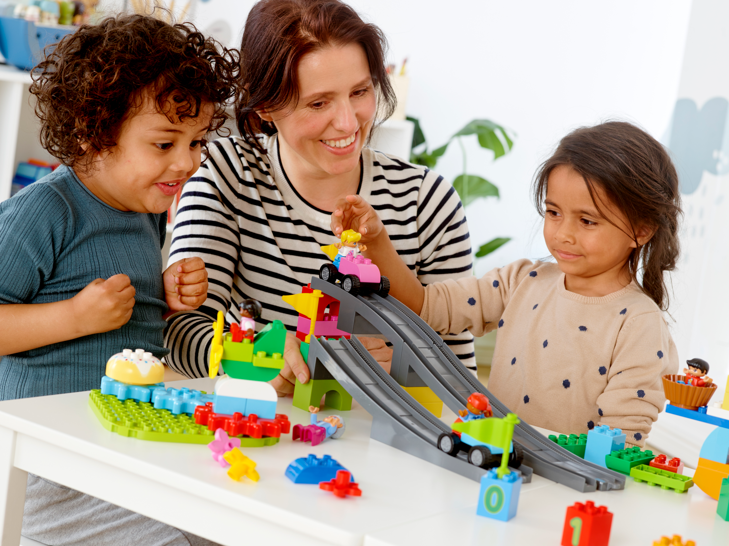 Two preschool children and a teacher building with LEGO Education STEAM Park